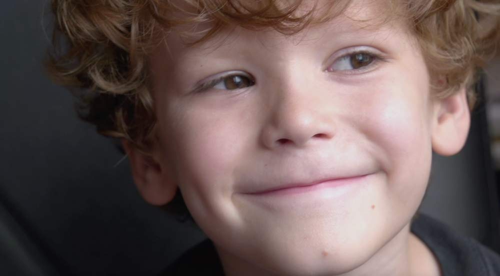 Smiling boy representing positive impact of chiropractic care
